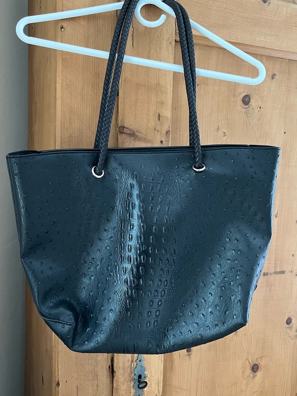 Vegan leather tote with textured animal print design.